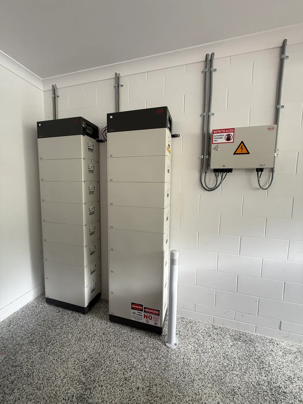 Stackable home battery bank and DC combiner installed by On Point Solar in a Townsville garage