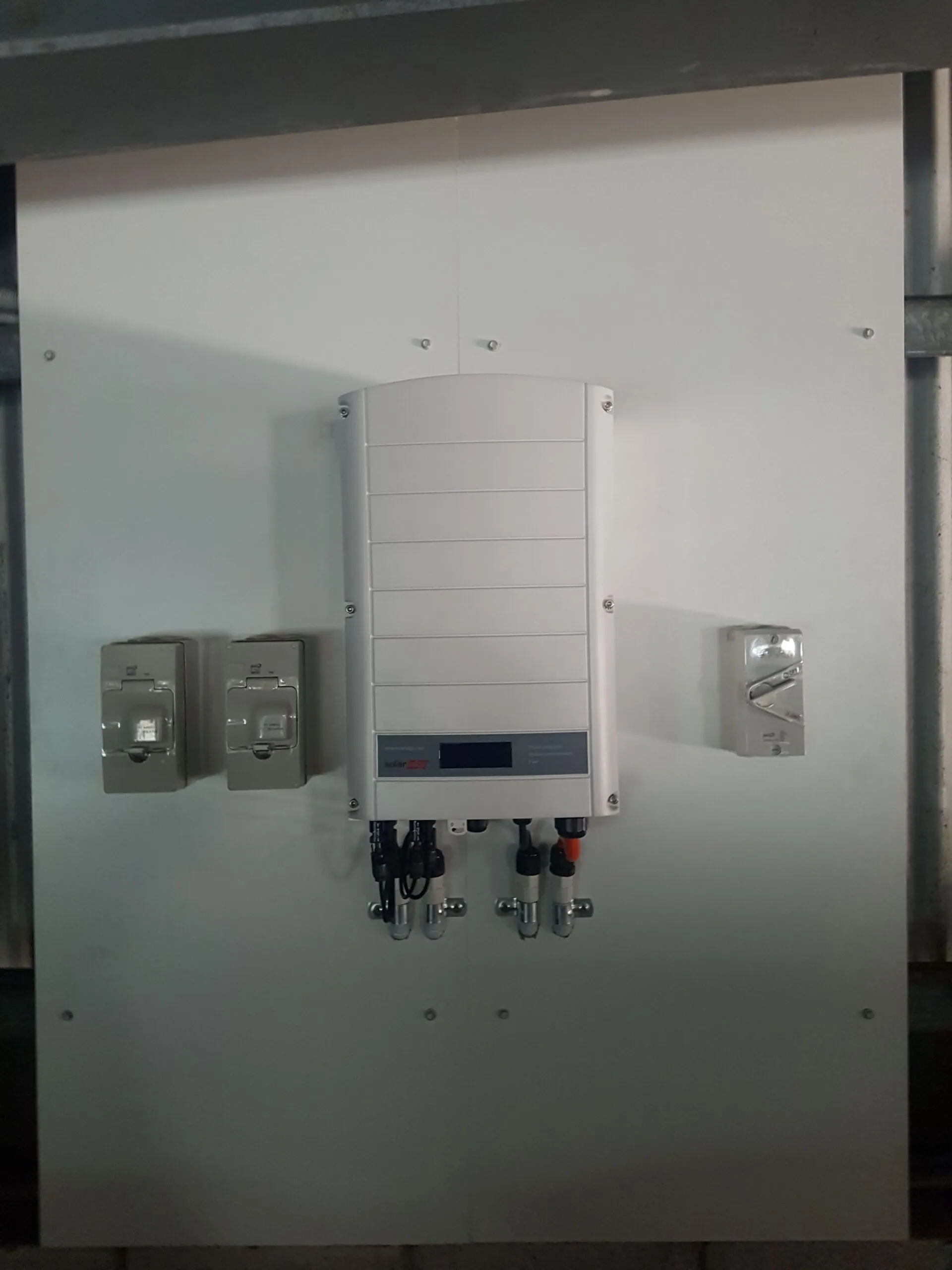 SolarEdge inverter and isolators wired to a clean board by On Point Solar & Electrical in Townsville