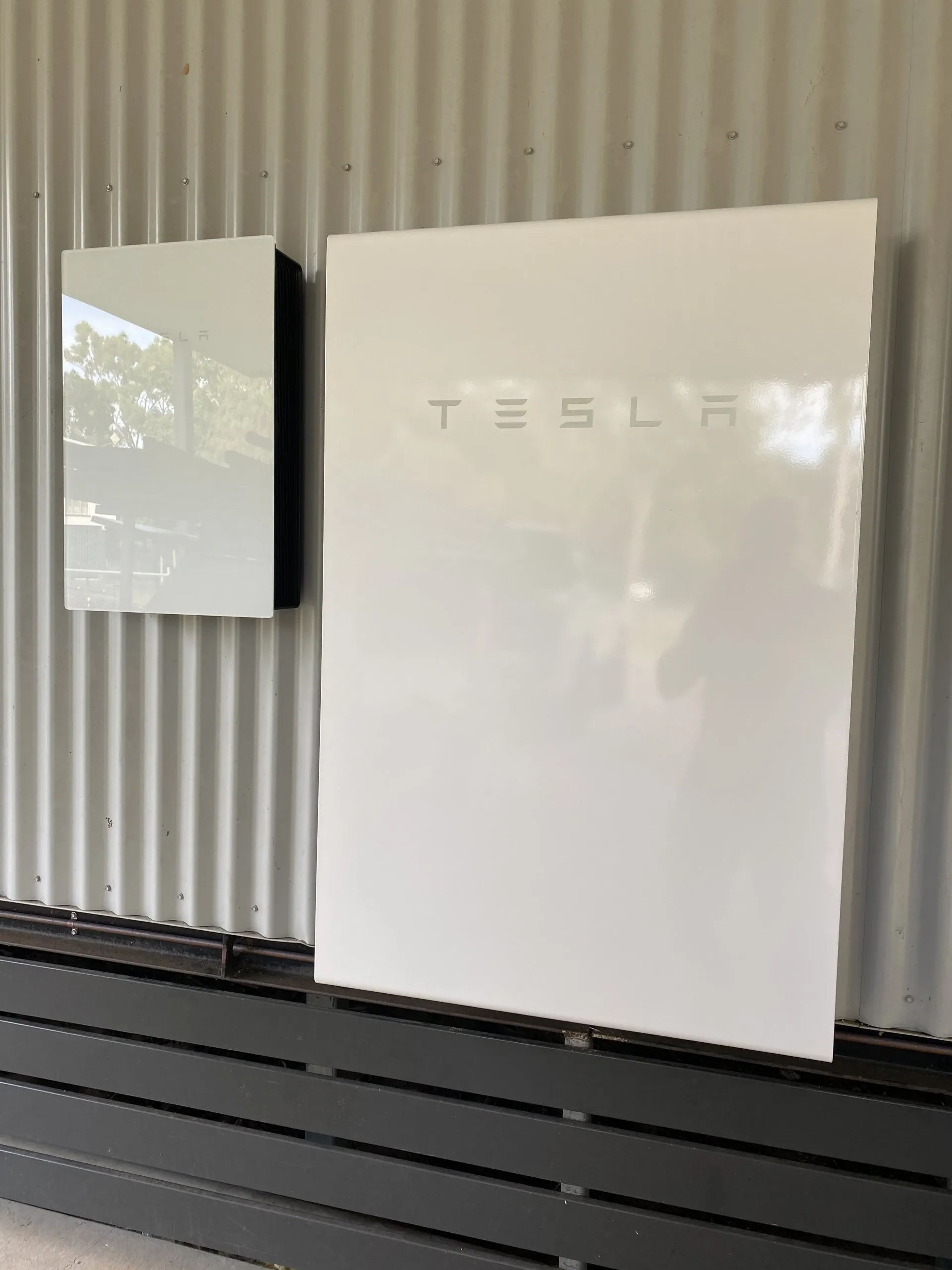 Tesla Powerwall installation Townsville — two Powerwall batteries mounted on a shed wall by On Point Solar